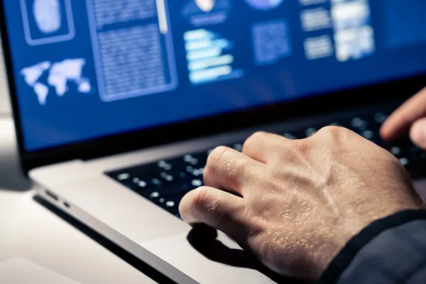 Stock image of hands typing on a laptop keyboard. Photo credit: Getty Images.
