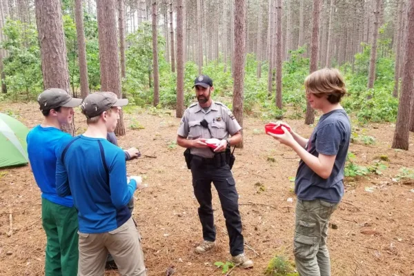 Conservation warden Ben Gruber interaction with young community members. Photo courtesy Ben Gruber for State Assembly.
