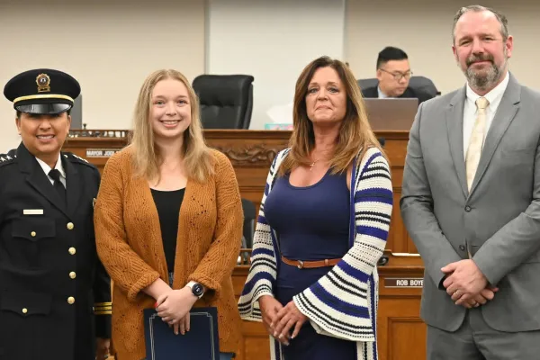 Matthews (second from left) receives a commendation from city leaders.