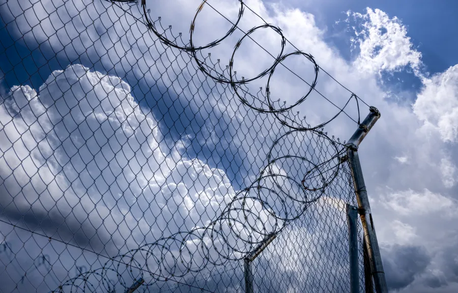 Stock image of barbed wire at a corrections facility. Photo credit: Getty Images.