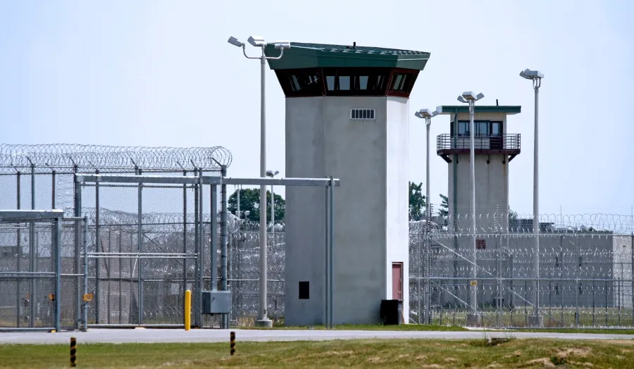Stock image of prison guard tower. Photo credit: Adobe Stock.