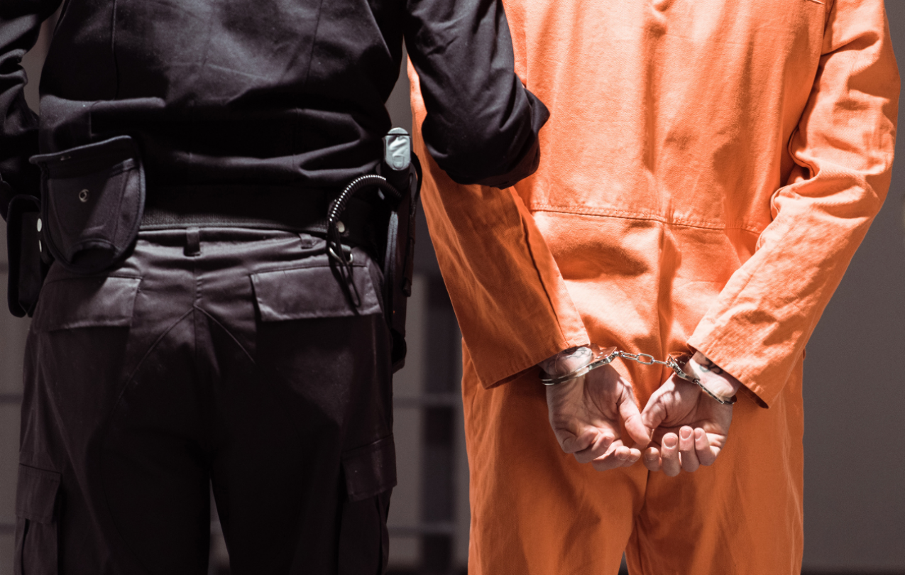 Stock image of a corrections officers escorting an inmate. Photo credit: Getty Images.