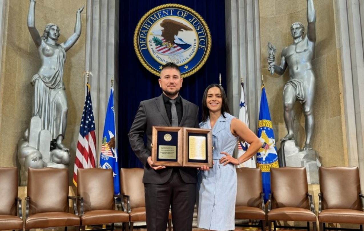 Gonzalez holding an award. Member provided photo.