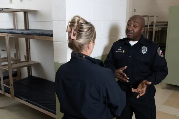 Officer Beamon speaking with one of his colleagues at a facility in Connecticut.