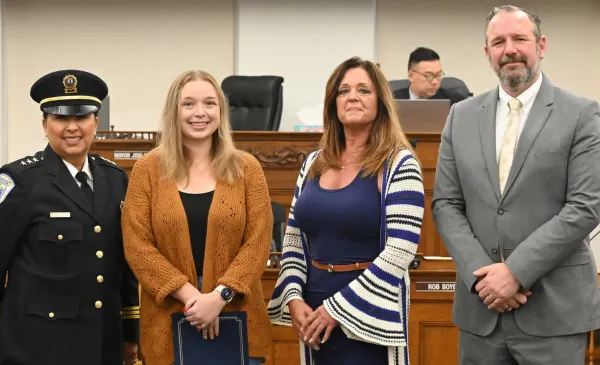 Matthews (second from left) receives a commendation from city leaders.