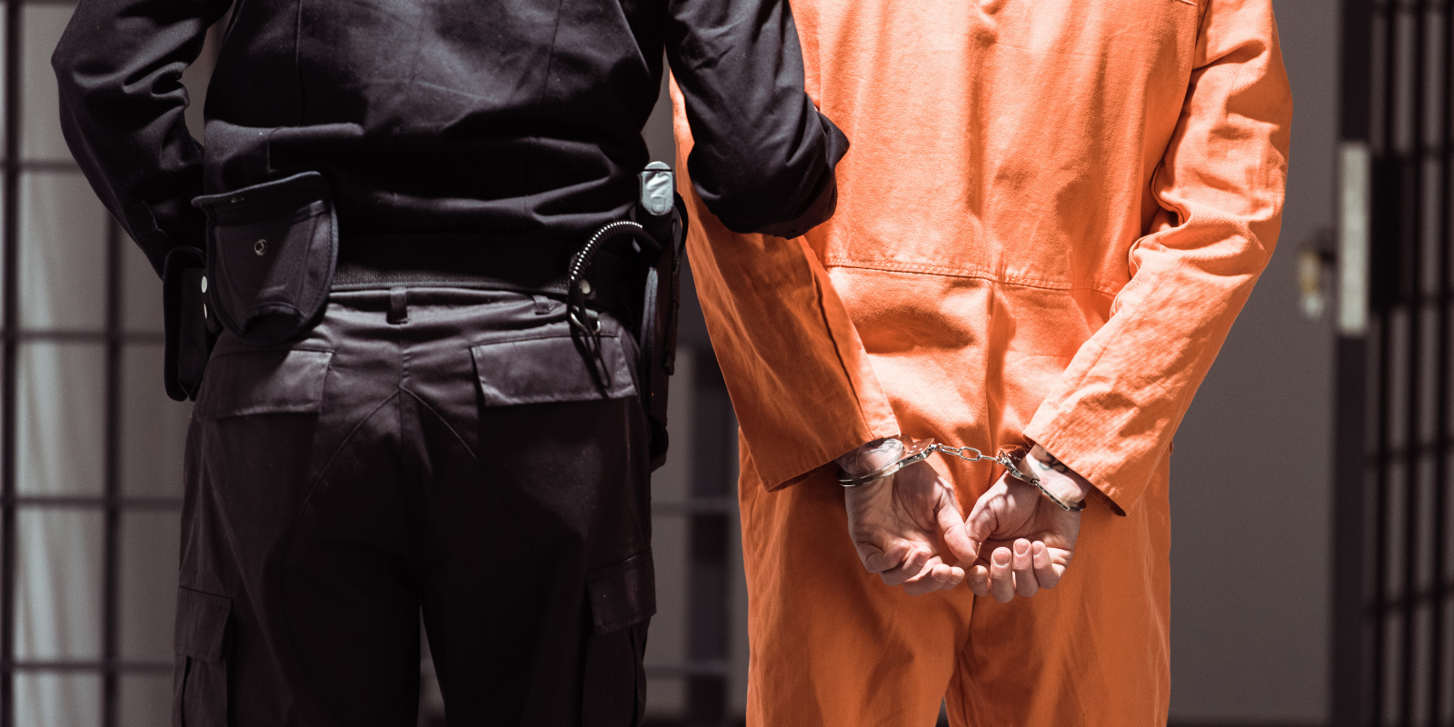 Stock image of a corrections officers escorting an inmate. Photo credit: Getty Images.